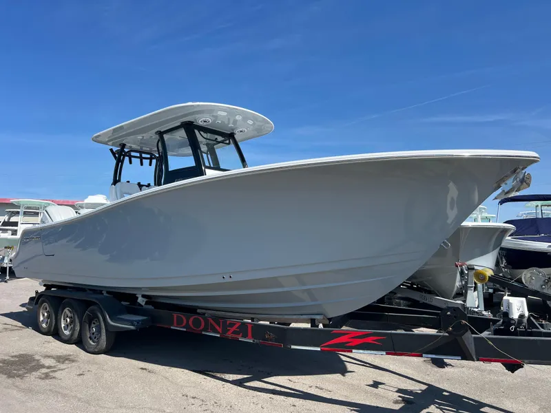 The Image of 2025 Sportsman Open 282 Center Console boat on trailer under clear blue sky. - 0