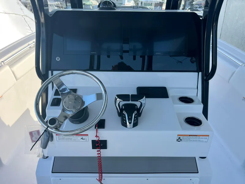 Slide: The Image of 2025 Sportsman Open 282 Center Console helm with steering wheel and controls. - 10