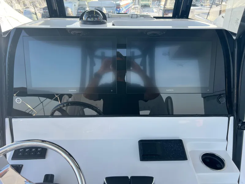 Slide: The Image of 2025 Sportsman Open 282 Center Console dashboard with dual screens and steering wheel. - 11