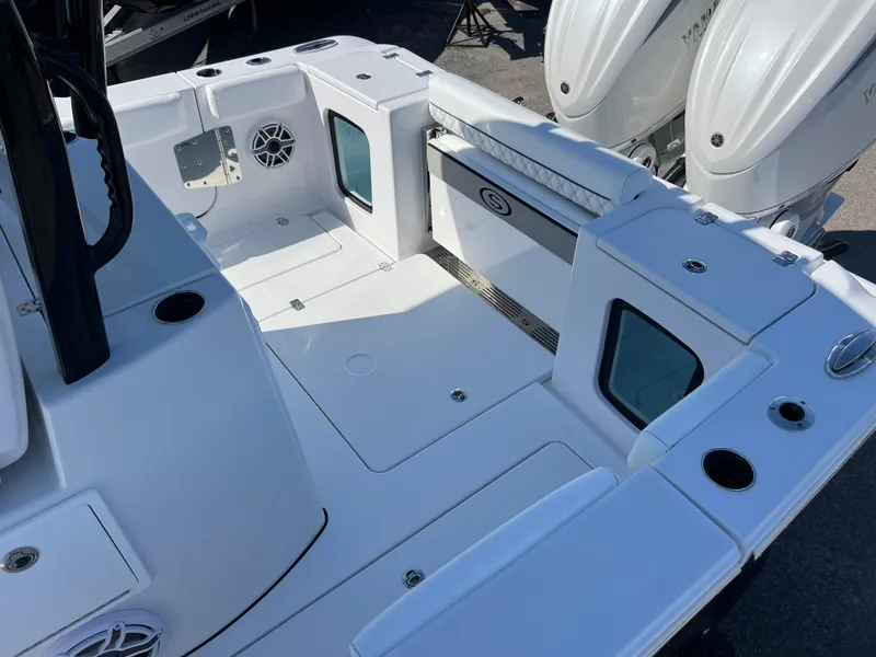 Slide: The Image of 2025 Sportsman Open 282 Center Console boat interior with dual engines and spacious deck. - 17