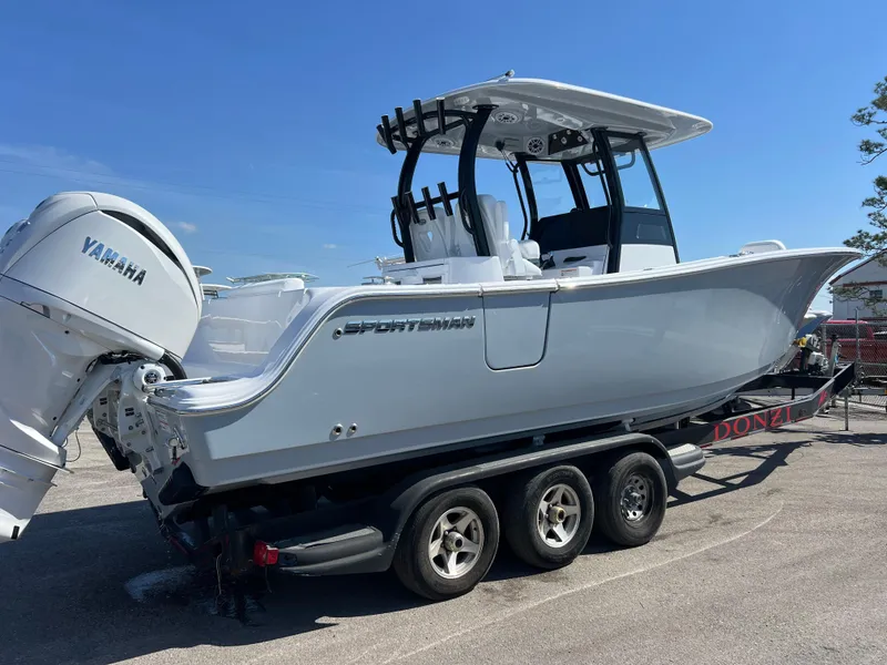 Slide: The Image of 2025 Sportsman Open 282 Center Console boat on trailer, featuring Yamaha engines. - 2