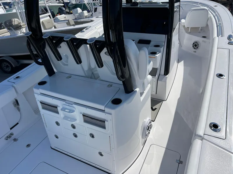 Slide: The Image of 2025 Sportsman Open 282 Center Console boat interior with seating and rod holders. - 7