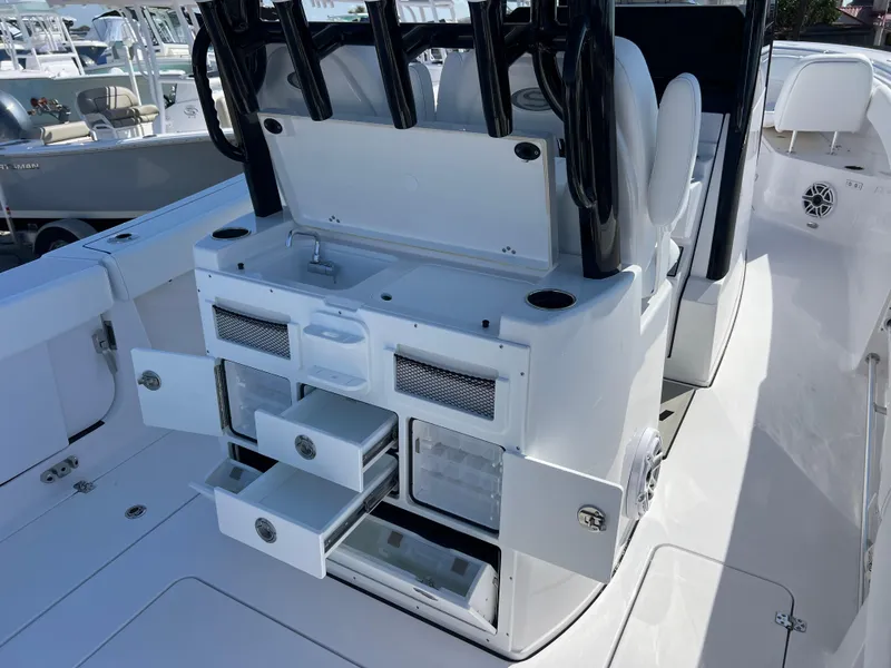 Slide: The Image of 2025 Sportsman Open 282 Center Console boat with open storage compartments and seating. - 8
