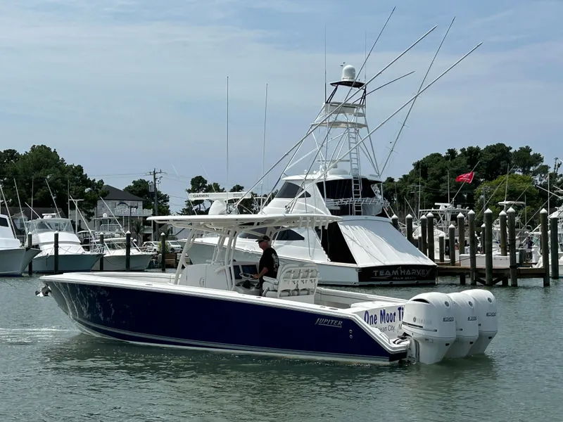 Slide: The Image of 2016 Jupiter 34 HFS boat with Triple Yamaha F300 engines docked in a marina. - 11