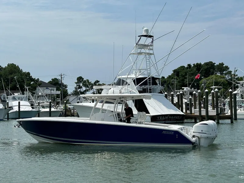 Slide: The Image of 2016 Jupiter 34 HFS boat with Triple Yamaha F300 engines docked in marina. - 12