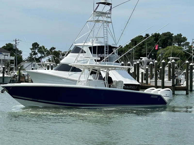 Slide: The Image of 2016 Jupiter 34 HFS boat with triple Yamaha F300 engines docked in a marina. - 13