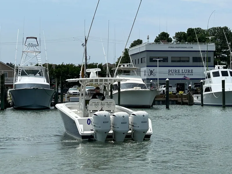 Slide: The Image of 2016 Jupiter 34 HFS boat with triple Yamaha F300 engines in a marina. - 14