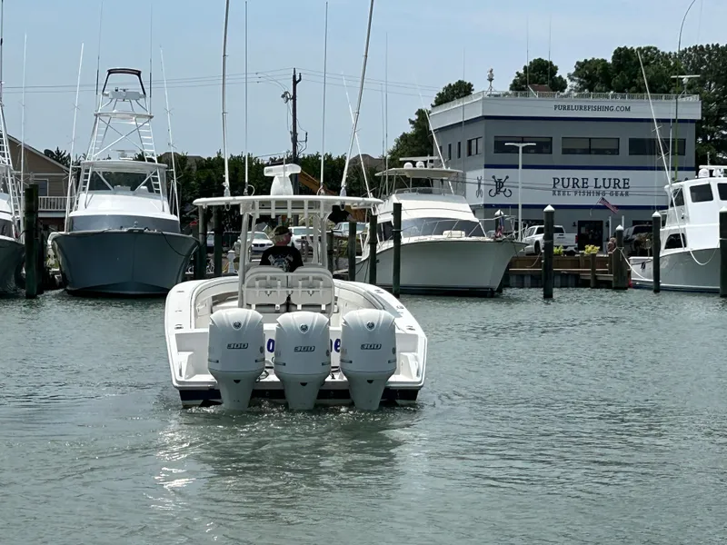 Slide: The Image of 2016 Jupiter 34 HFS boat with Triple Yamaha F300 engines docked at a marina. - 15
