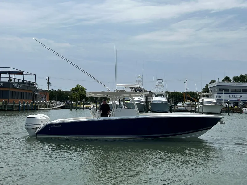 Slide: The Image of 2016 Jupiter 34 HFS boat with Triple Yamaha F300s in a marina. - 18