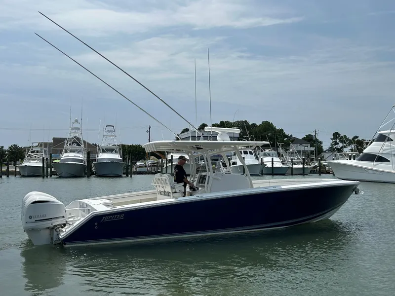 Slide: The Image of 2016 Jupiter 34 HFS boat with triple Yamaha F300 engines docked in a marina. - 22