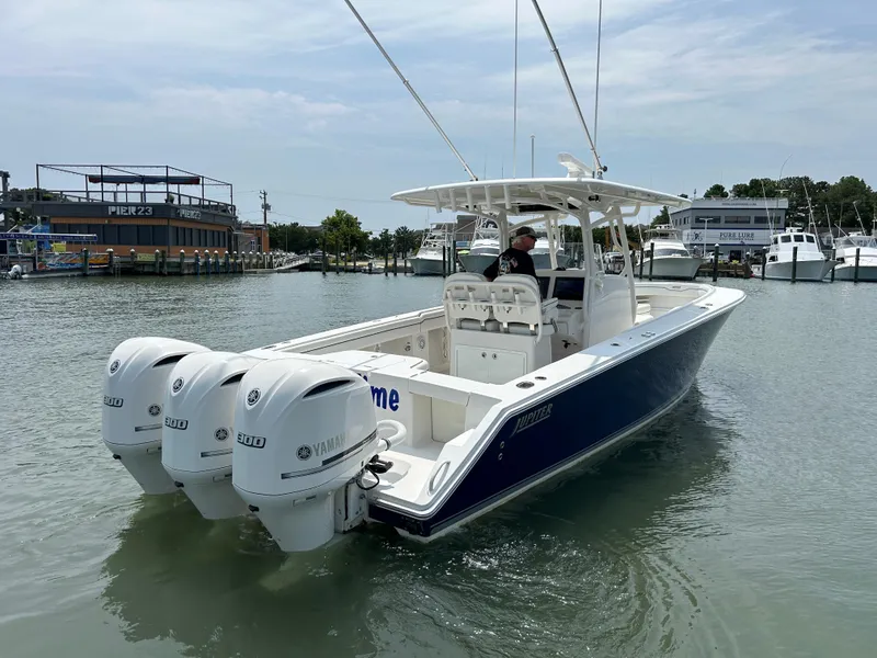 Slide: The Image of 2016 Jupiter 34 HFS boat with triple Yamaha F300 engines on the water. - 24