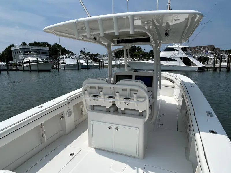 Slide: The Image of 2016 Jupiter 34 HFS boat with Triple Yamaha F300s at a marina. - 26