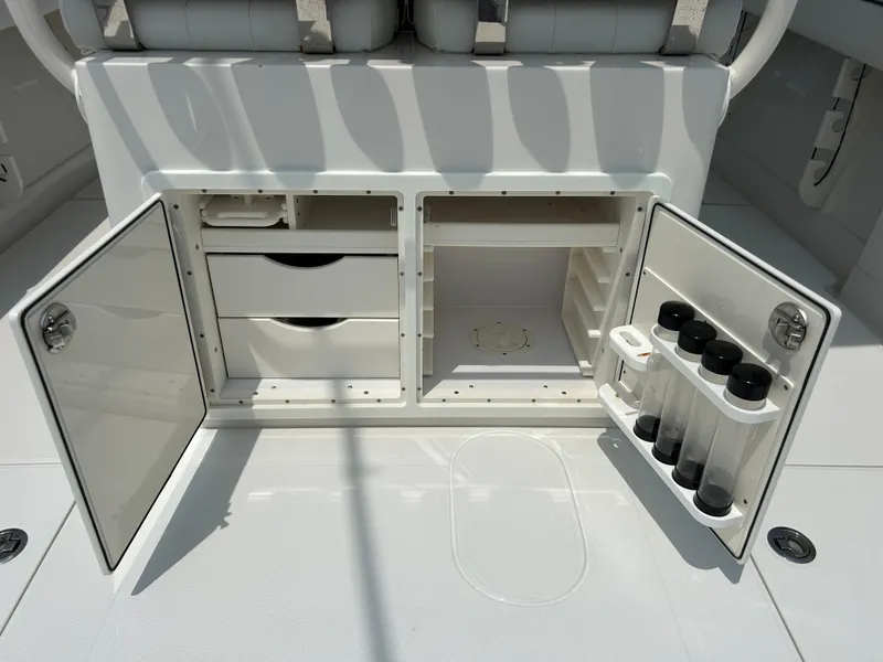 Slide: The Image of 2016 Jupiter 34 HFS boat storage compartments with open doors and organized shelves. - 27