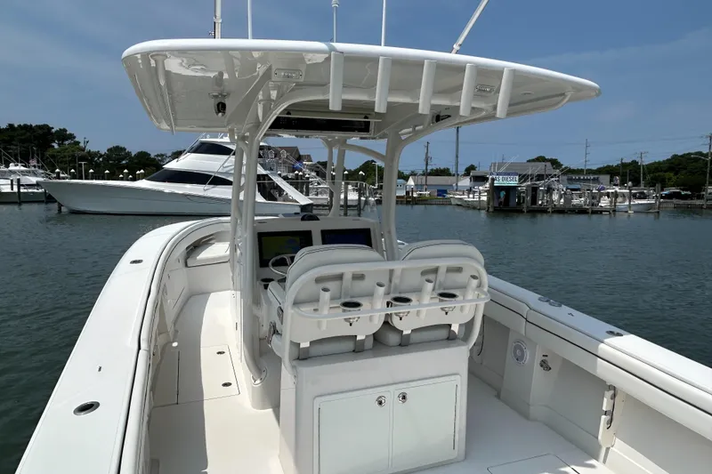 Slide: The Image of 2016 Jupiter 34 HFS boat with Triple Yamaha F300s at a marina. - 28