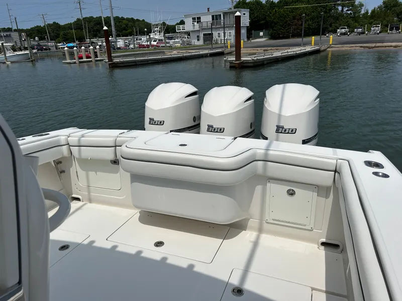 Slide: The Image of 2016 Jupiter 34 HFS boat with triple Yamaha F300 engines docked at marina. - 32