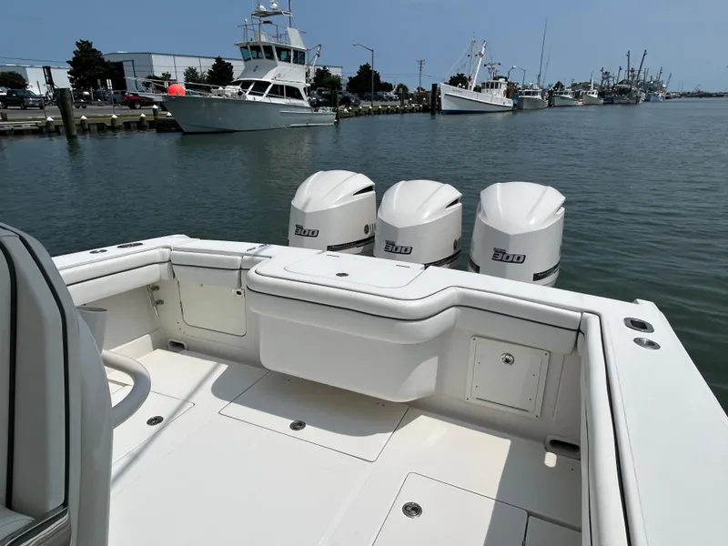 Slide: The Image of 2016 Jupiter 34 HFS boat with triple Yamaha F300 engines docked in a marina. - 33