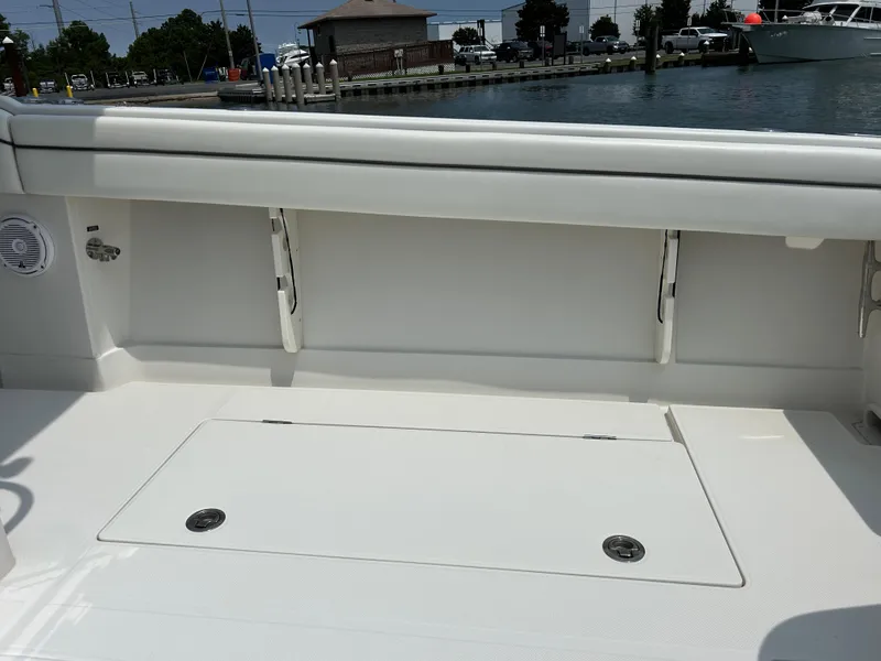 Slide: The Image of 2016 Jupiter 34 HFS boat interior with storage compartments and clean white deck. - 34