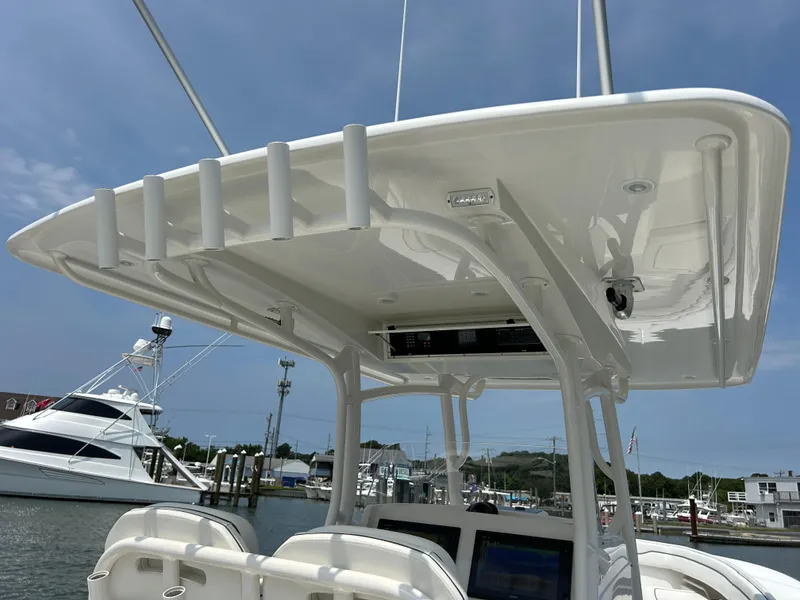 Slide: The Image of 2016 Jupiter 34 HFS boat with Triple Yamaha F300s at a marina. - 38