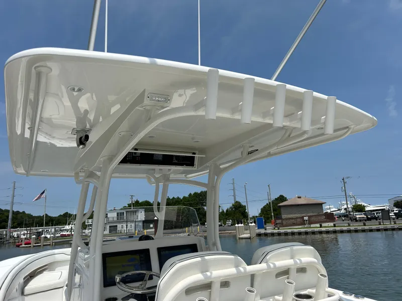 Slide: The Image of 2016 Jupiter 34 HFS boat with Triple Yamaha F300s at a marina. - 39