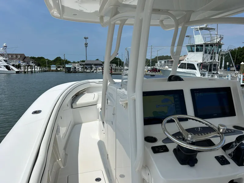 Slide: The Image of 2016 Jupiter 34 HFS boat with Triple Yamaha F300s at a marina. - 40