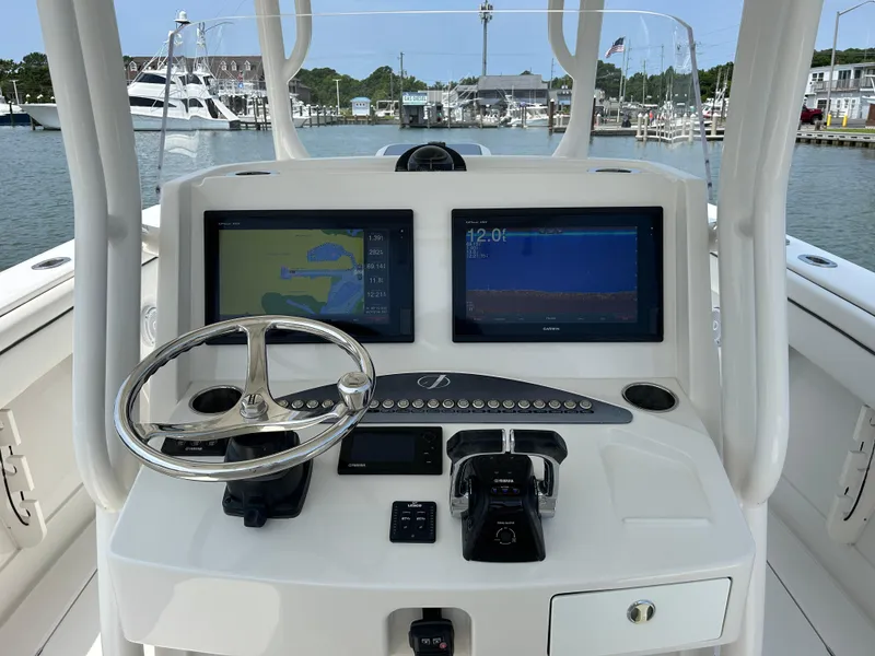 Slide: The Image of 2016 Jupiter 34 HFS boat console with dual navigation screens and steering wheel. - 46