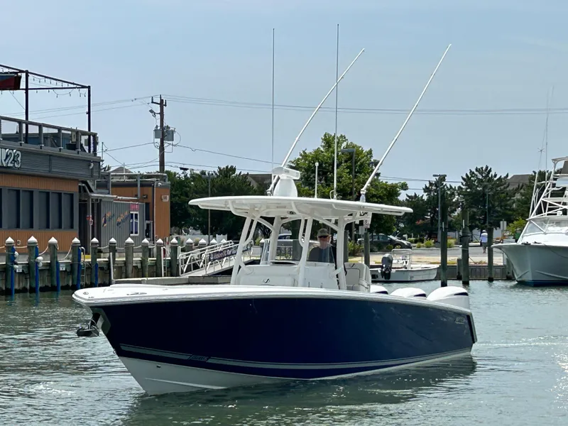 Slide: The Image of 2016 Jupiter 34 HFS boat with Triple Yamaha F300 engines docked in a marina. - 5