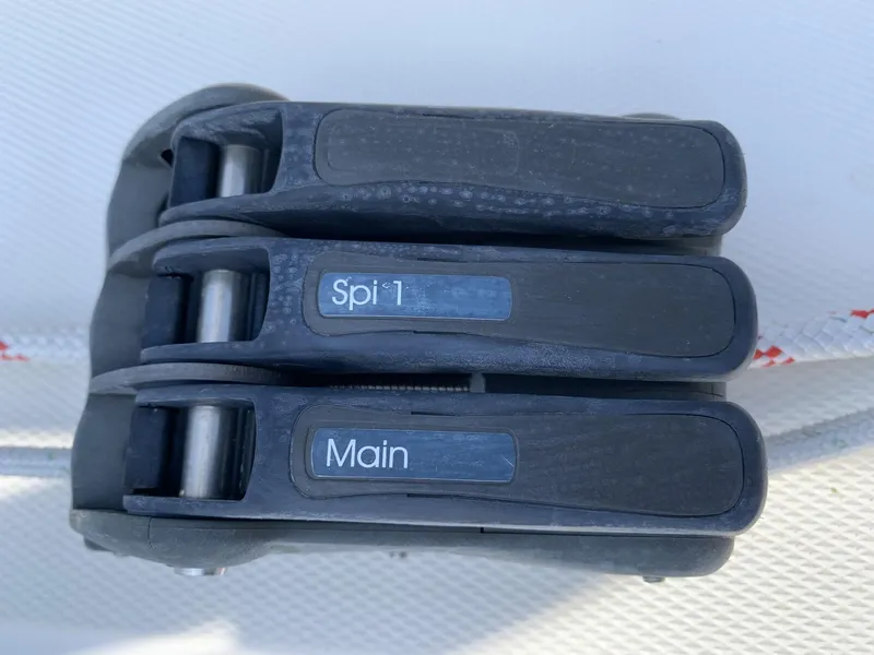 Slide: The Image of Close-up of Sparkman & Stephens 30 sailboat rope clutches labeled "Spi 1" and "Main," 2017 model. - 13
