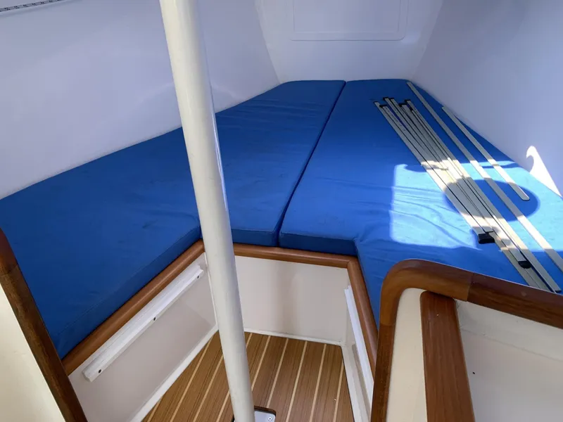 Slide: The Image of Interior of 2017 Sparkman & Stephens 30 sailboat with blue cushions and wooden flooring. - 17
