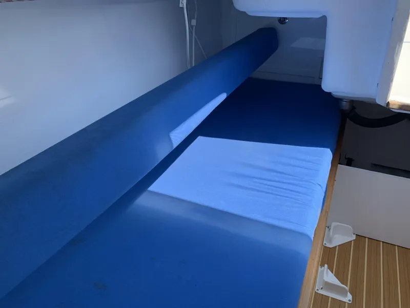 Slide: The Image of Interior of a 2017 Sparkman & Stephens 30 sailboat with blue cushioned seating. - 20