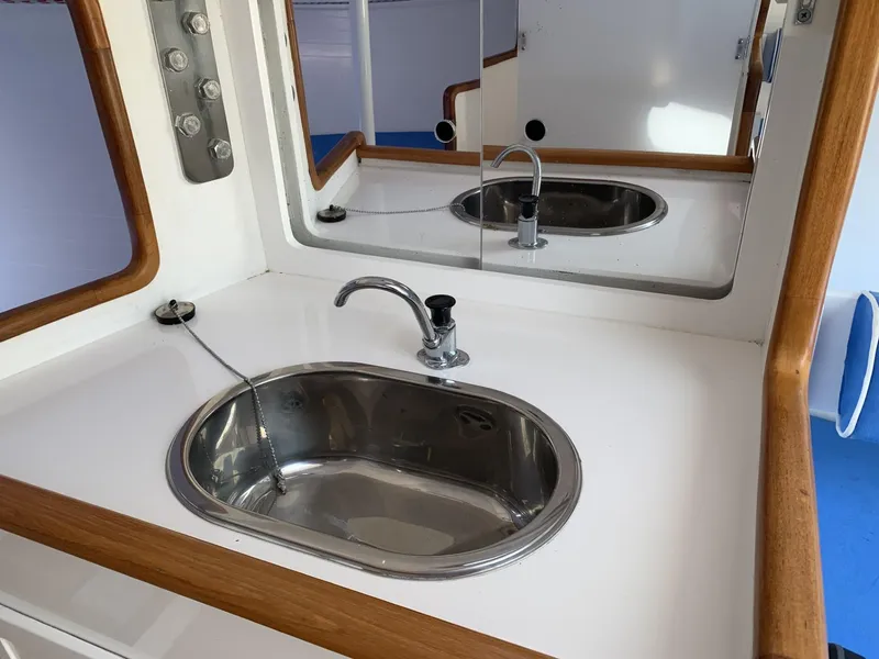 Slide: The Image of Modern sink area in 2017 Sparkman & Stephens 30 yacht, featuring sleek design and wood accents. - 21