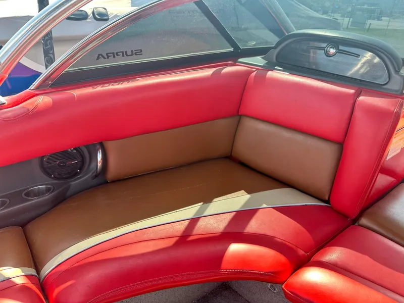 Slide: The Image of 2009 Supra 21V LAUNCH boat interior with red and brown leather seating. - 7