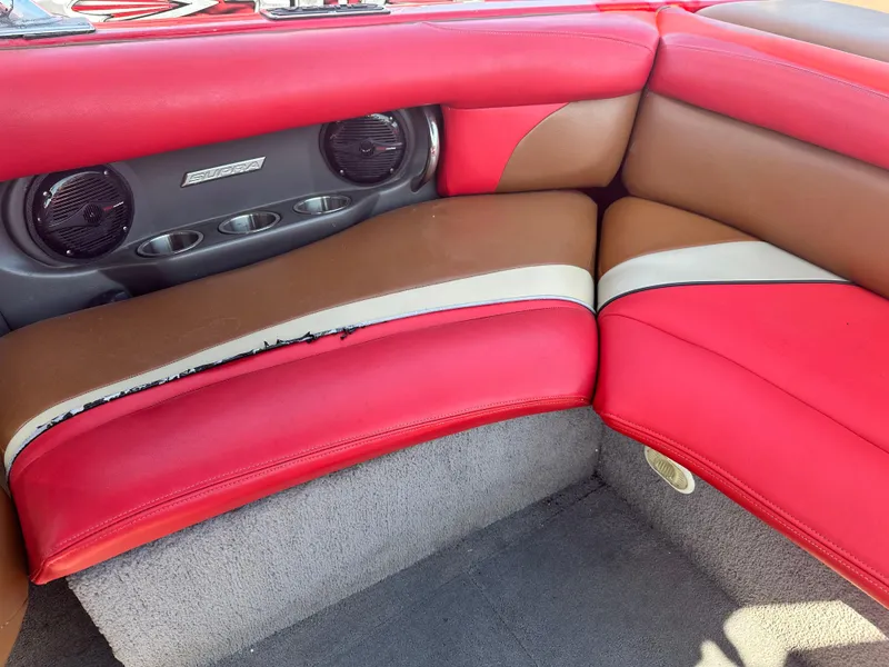 Slide: The Image of 2009 Supra 21V LAUNCH boat interior with red, brown, and white seating. - 9