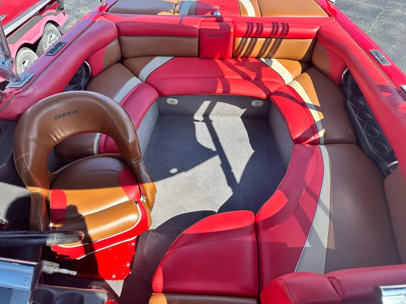 Slide: The Image of 2009 Supra 21V LAUNCH boat with red and tan interior seating. - 11