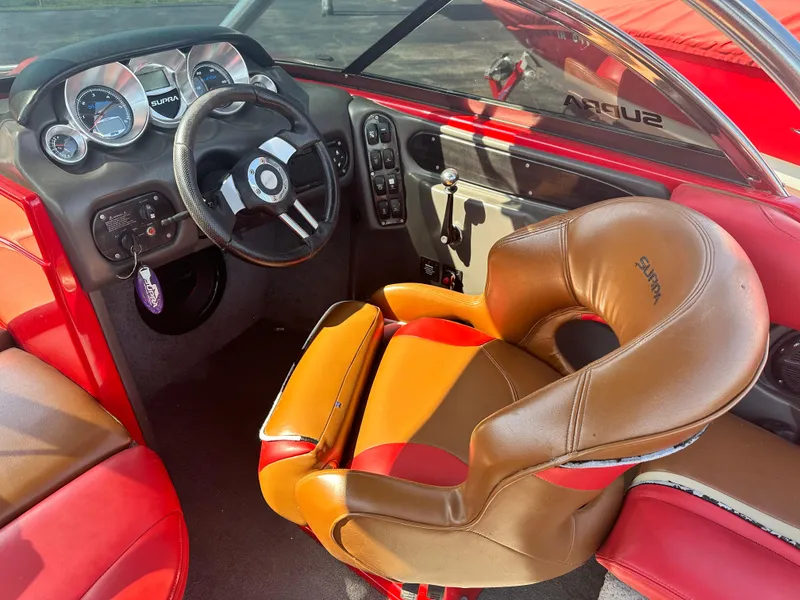 Slide: The Image of 2009 Supra 21V LAUNCH boat interior with steering wheel and captain's chair. - 8