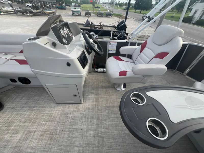 Slide: The Image of 2022 SunCatcher Select 18C boat interior with captain's chair and control console. - 10
