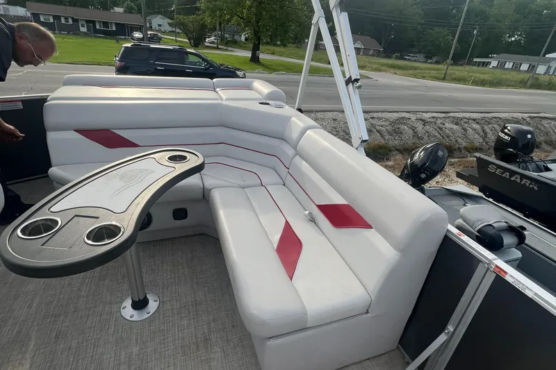 Slide: The Image of 2022 SunCatcher Select 18C pontoon boat interior with white and red seating and table. - 11
