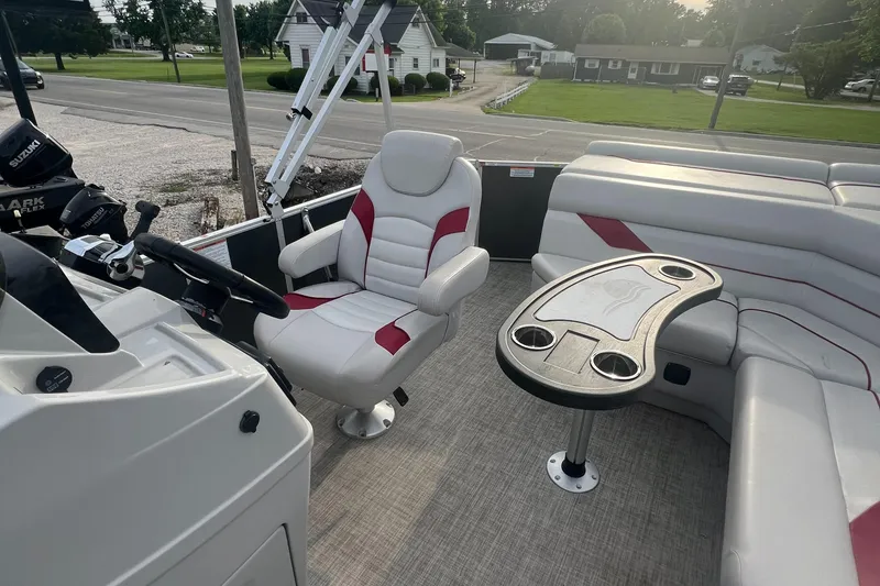 Slide: The Image of 2022 SunCatcher Select 18C boat interior with captain's chair and seating area. - 13