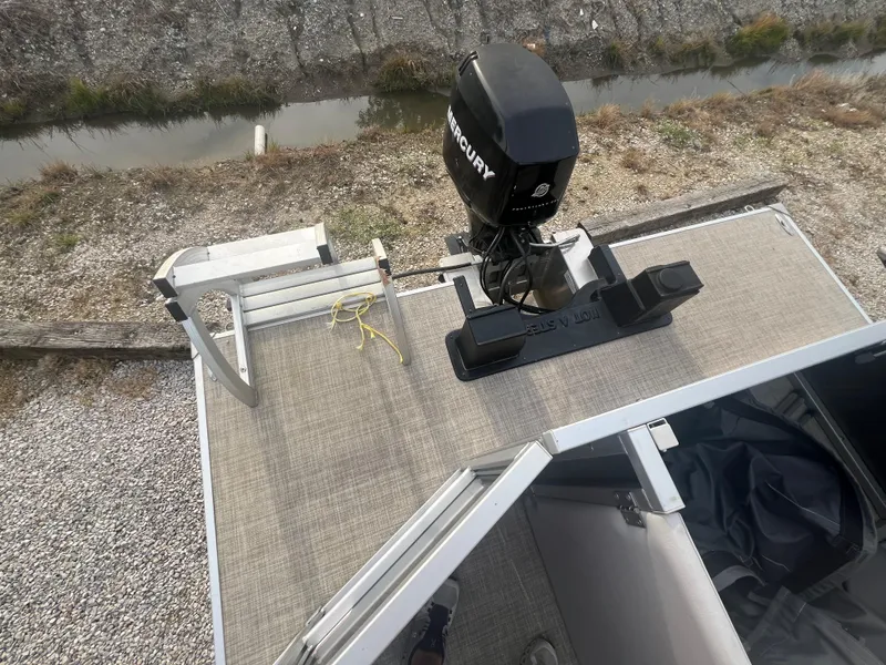 Slide: The Image of 2022 SunCatcher Select 18C boat with Mercury outboard motor, rear deck view. - 14