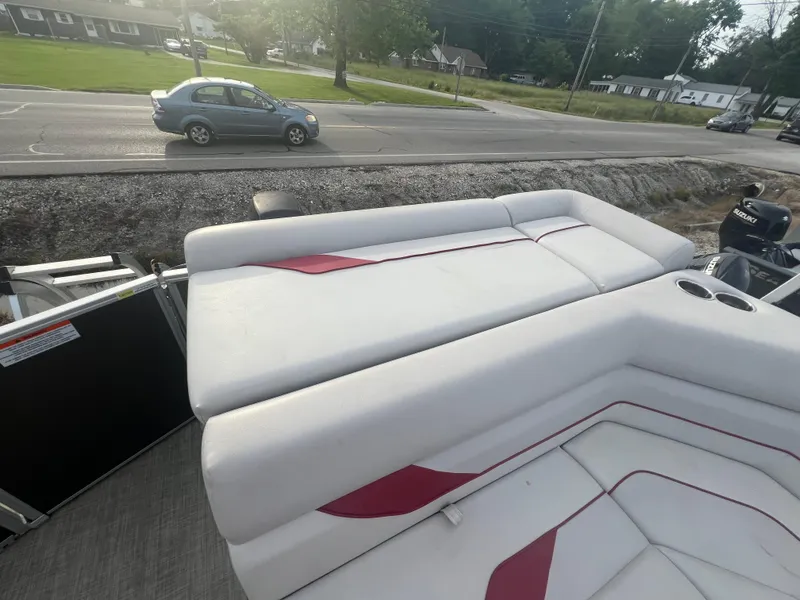 Slide: The Image of 2022 SunCatcher Select 18C boat with white and red cushioned seating. - 15