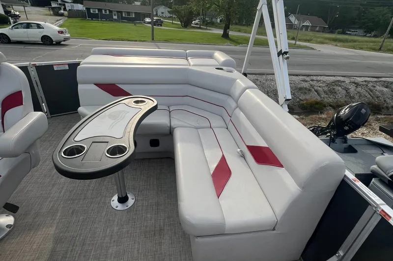 Slide: The Image of 2022 SunCatcher Select 18C pontoon boat with white and red seating and a table. - 7