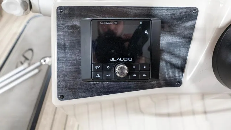 Slide: The Image of JL Audio system on the 2021 Harris SUNLINER 230 SLDH boat dashboard. - 10