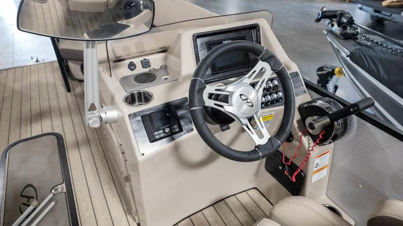 Slide: The Image of 2021 Harris SUNLINER 230 SLDH boat dashboard with steering wheel and control panel. - 11