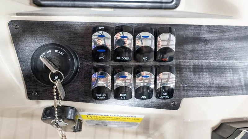 Slide: The Image of Control panel of a 2021 Harris SUNLINER 230 SLDH boat with ignition key and switches. - 14
