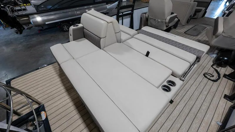Slide: The Image of 2021 Harris SUNLINER 230 SLDH boat interior with spacious seating and cup holders. - 20