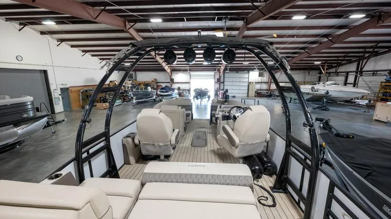 Slide: The Image of 2021 Harris SUNLINER 230 SLDH pontoon boat interior in a warehouse. - 23