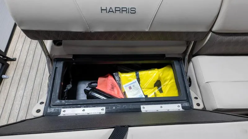 Slide: The Image of Storage compartment in 2021 Harris SUNLINER 230 SLDH boat with life jackets and safety gear. - 24