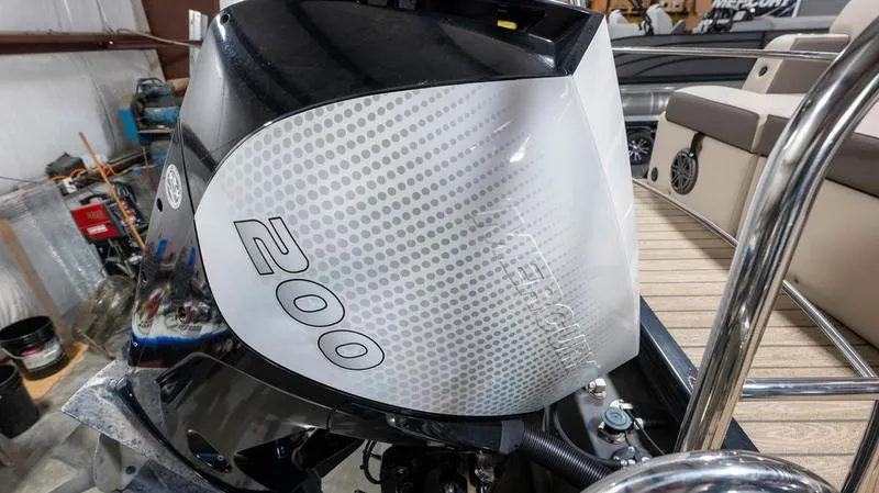 Slide: The Image of 2021 Harris SUNLINER 230 SLDH boat engine, 200 horsepower, in a storage facility. - 30