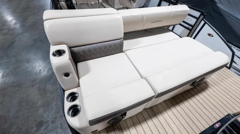 Slide: The Image of 2021 Harris SUNLINER 230 SLDH boat interior with beige seating and cup holders. - 31