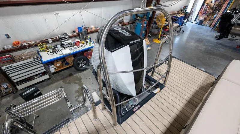 Slide: The Image of 2021 Harris SUNLINER 230 SLDH pontoon boat with Mercury outboard motor in a workshop. - 32