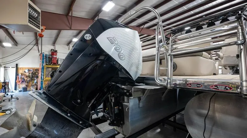 Slide: The Image of 2021 Harris SUNLINER 230 SLDH pontoon boat with 200 HP engine in a workshop. - 33